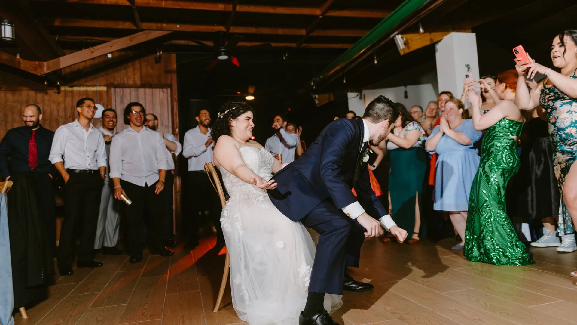 Couple dancing among guests next to a batucada drum