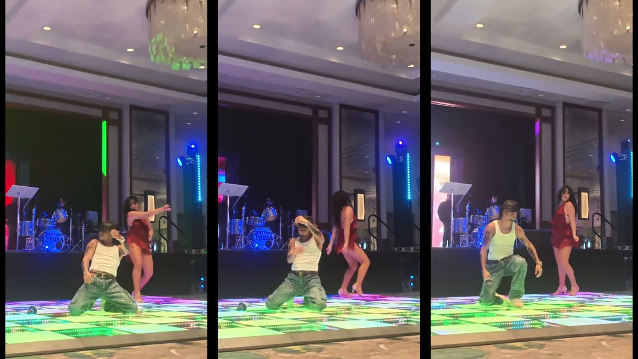 Show lookalike de artista urbano con bailarina sobre una pista iluminada